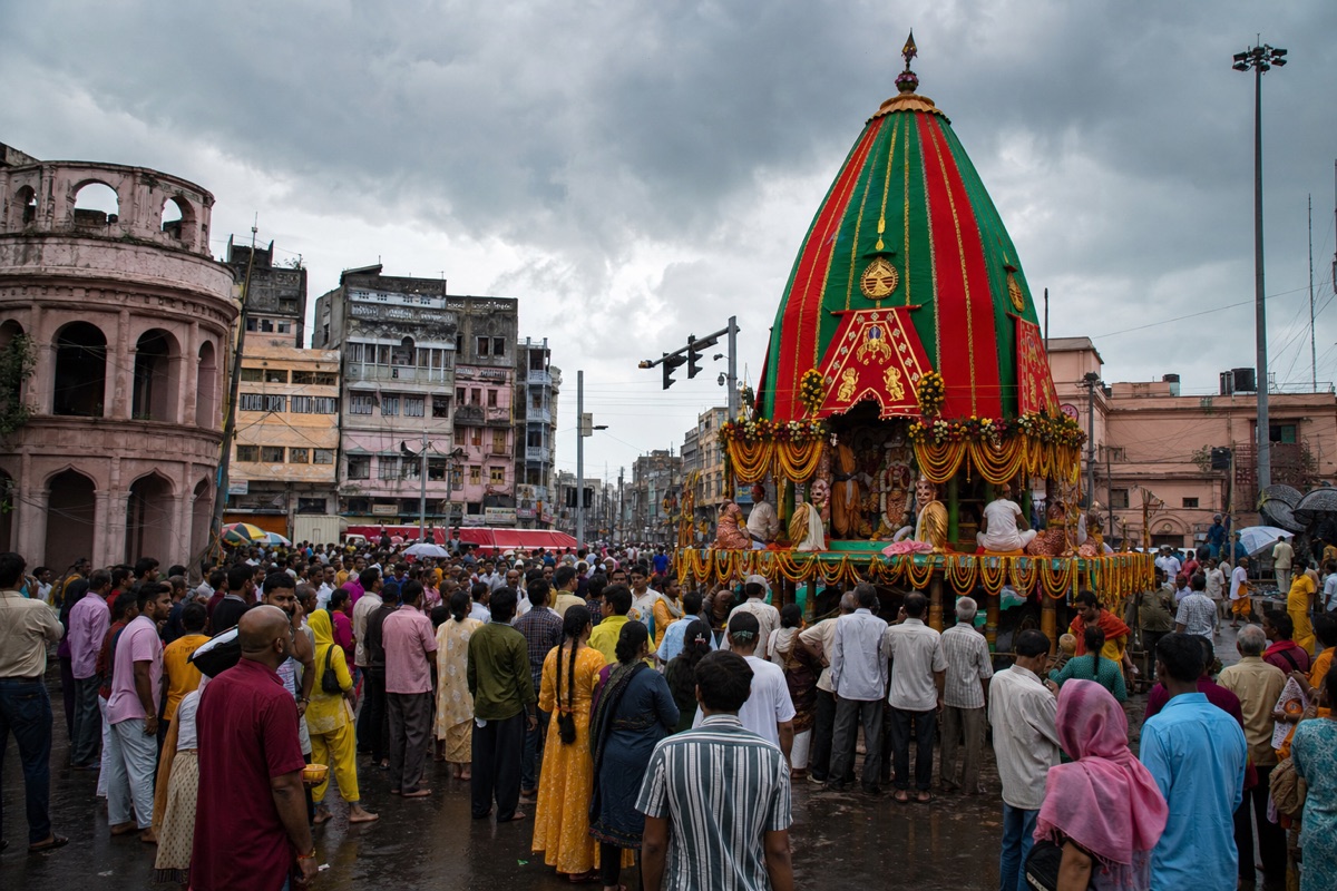 Decorated wooden Jagannath chariot surrounded by devotees at Varanasi’s Rath Yatra crossing