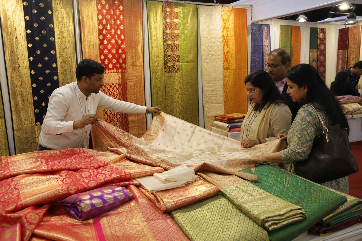 Detailed Banarasi silk and zari textiles displayed at a professional trade exhibition