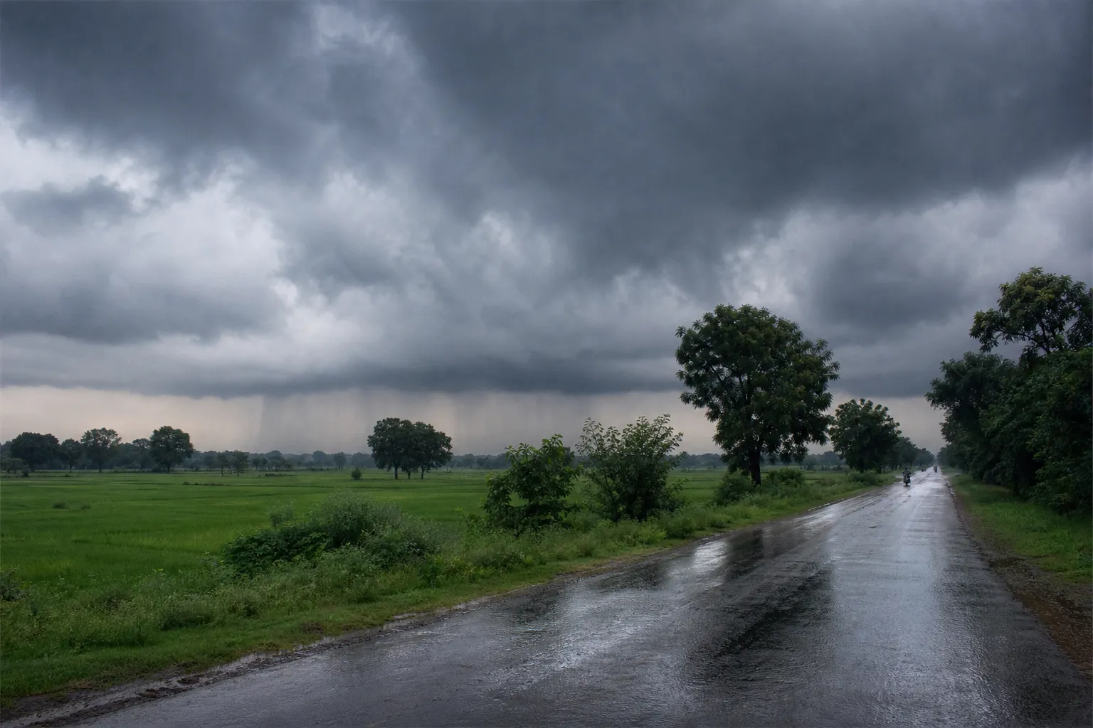 Representative monsoon clouds and rain over an eastern Uttar Pradesh road and farmland
