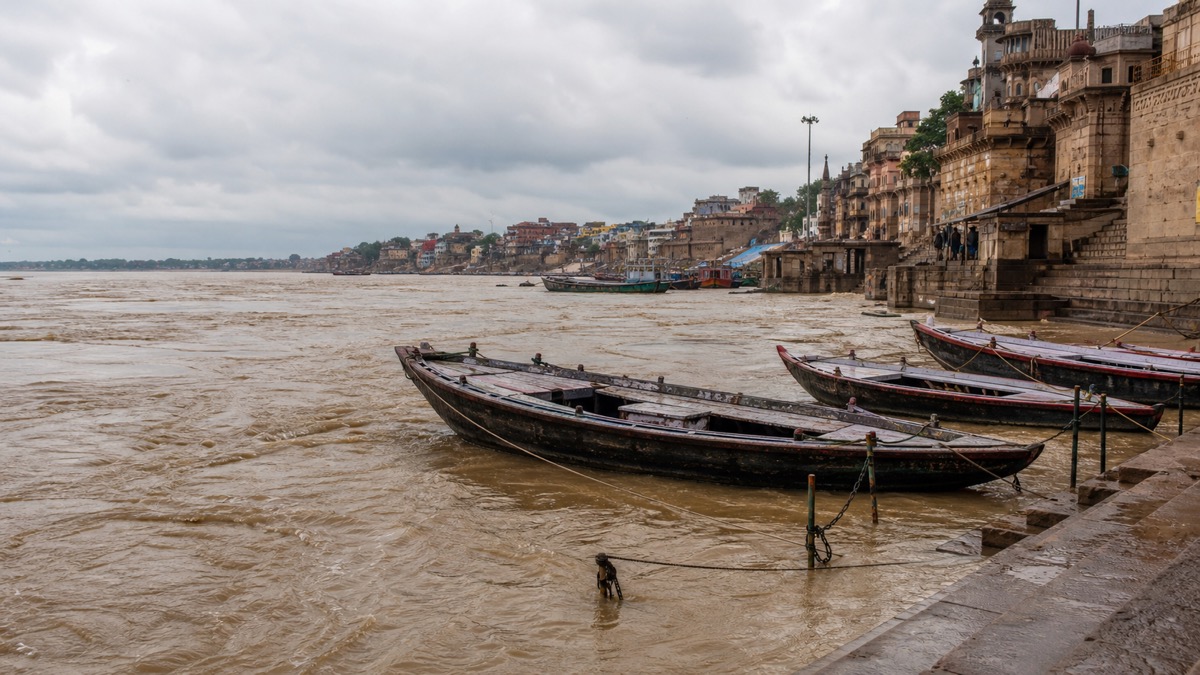 Idle wooden boats tied beside the swollen Ganga at Varanasi ghats