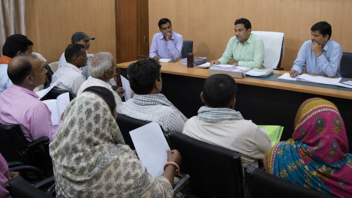 Residents presenting written grievances during a civic public hearing in Rohania