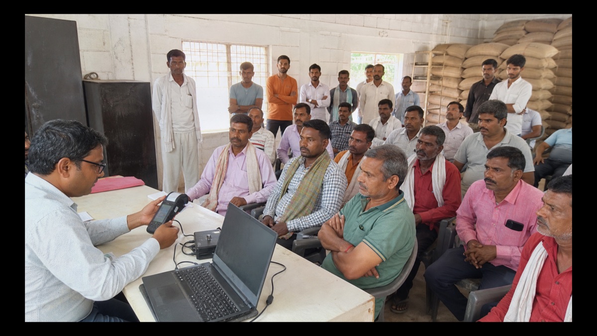 Fair-price shop dealers attending a demonstration of a digital ration terminal