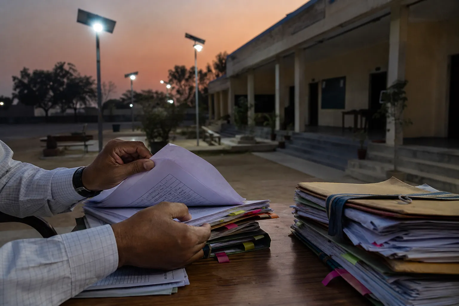 Village streetlight beside panchayat files during a Gurugram fund investigation