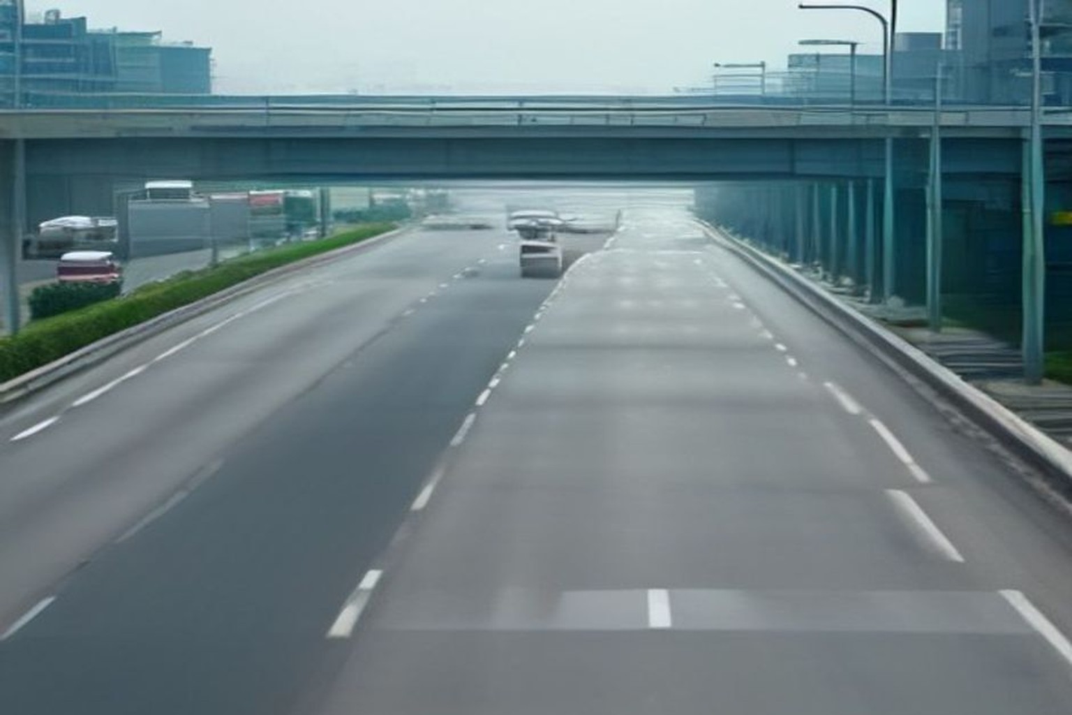 Illustrative multi-lane expressway under daylight with blurred traffic motion and empty shoulder, no plates or readable signs
