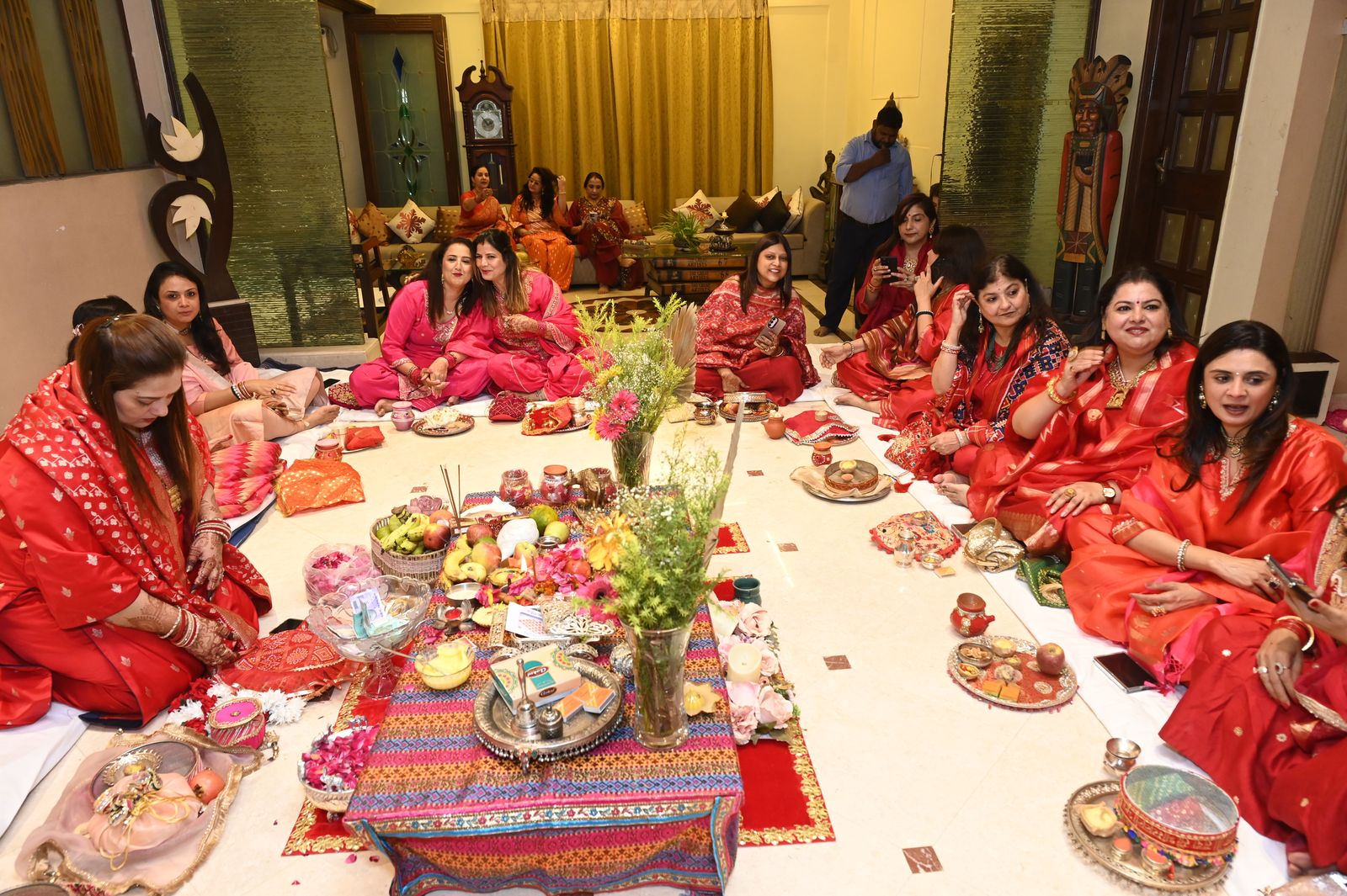 Women gathered around the Karwa Chauth puja arrangement Karwa Chauth get-together, Varanasi