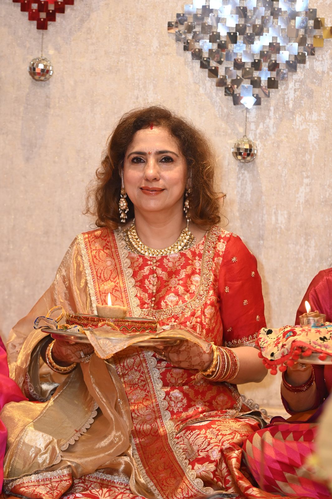 A guest with her puja thali, Karwa Chauth get-together, Varanasi